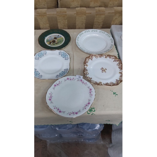 51 - Collection of five decorative porcelain plates with varied floral and animal designs, rimmed with go... 