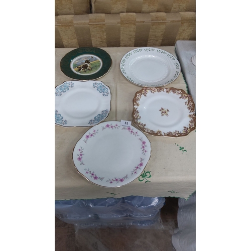 51 - Collection of five decorative porcelain plates with varied floral and animal designs, rimmed with go... 