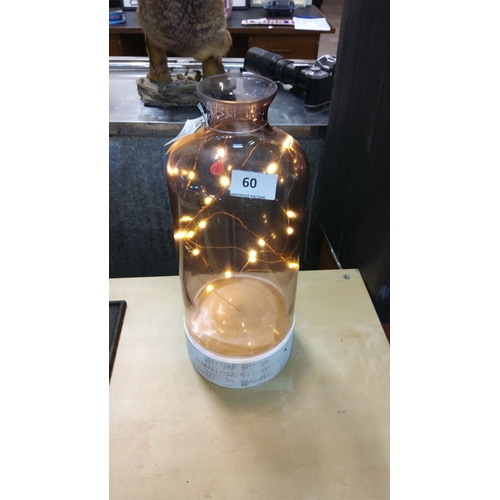 60 - Decorative glass vase with integrated LED string lights, creating a warm ambient glow.