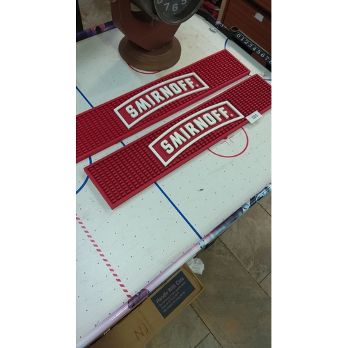 101 - Pair of Smirnoff branded red rubber bar mats, featuring bold white logo.