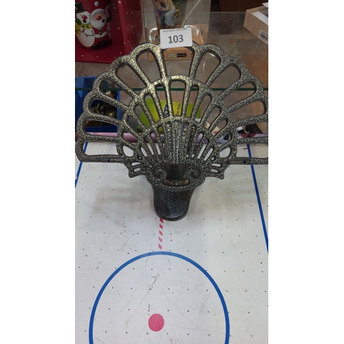 103 - Cast iron book/menu stand with a peacock tail design, featuring a textured, speckled finish.