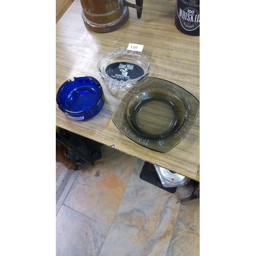 110 - Set of three glass ashtrays: vibrant blue Bavaria, clear Innsbruck Tirol, and dark-tinted Roundhouse... 