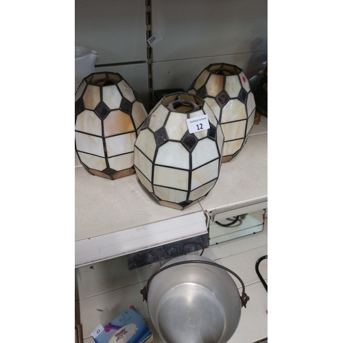 12 - Set of three geometric stained glass lampshades, featuring hexagonal and square patterns in muted cr... 