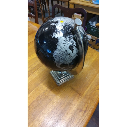 31 - Contemporary black and silver globe with metal base, featuring detailed map and modern design.