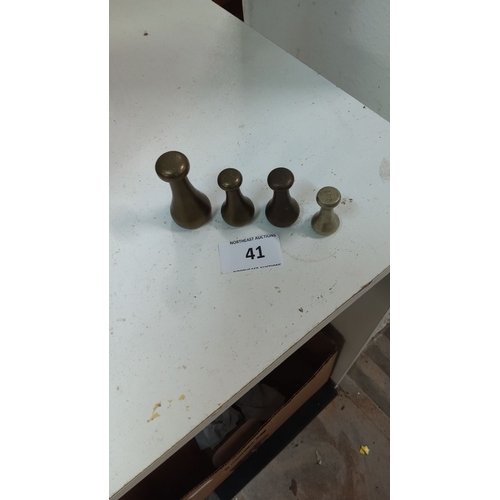 41 - Set of four vintage brass apothecary weights in graduated sizes.