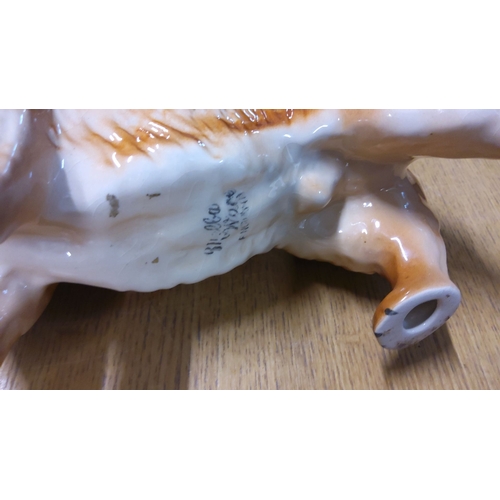 44 - Ceramic figurine of a Corgi dog, glazed finish. Marked 