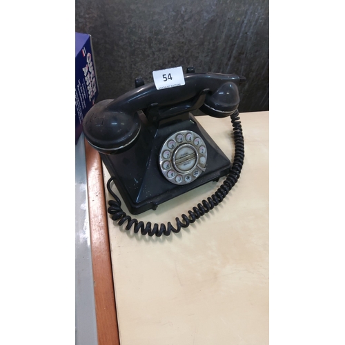 54 - Vintage telephone, black Bakelite, from the mid-20th century with a coiled cord.