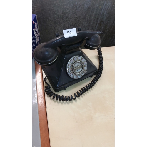 54 - Vintage telephone, black Bakelite, from the mid-20th century with a coiled cord.