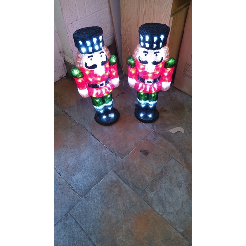 57 - Pair of illuminated Nutcracker figures, vibrant multi-colored design, height approx. 2 feet.