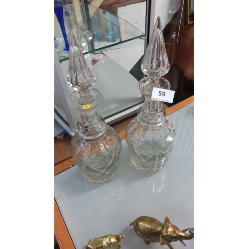 59 - Pair of cut crystal decanters with faceted stoppers.