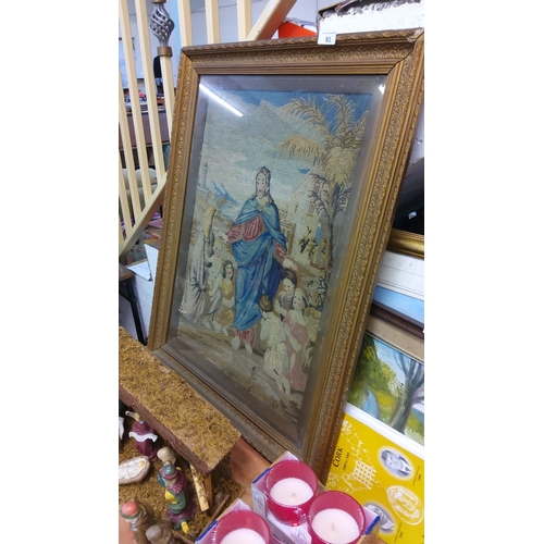 81 - Framed tapestry depicting a religious scene with a central figure in red and blue garments surrounde... 