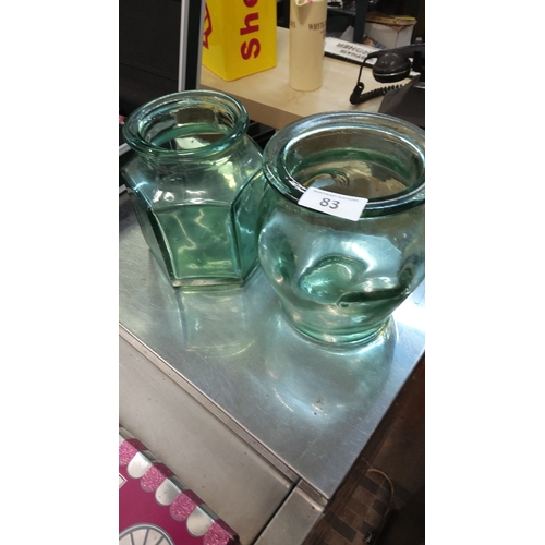 83 - Pair of vintage green glass jars with wide openings.