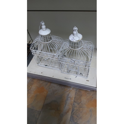 156 - Pair of decorative vintage-style metal birdcages, with a white painted finish, detailed with floral ... 