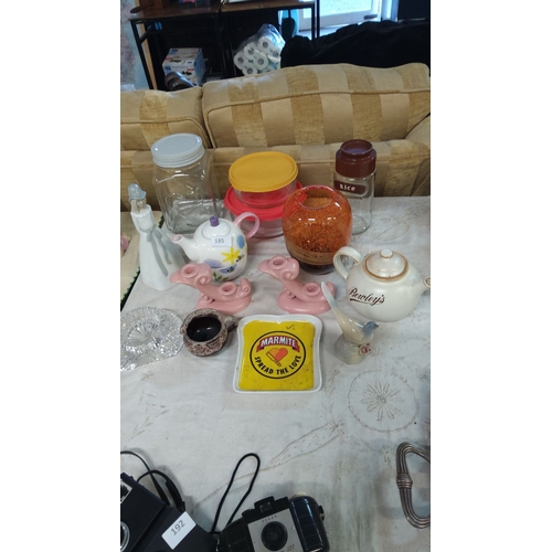 185 - Vintage lot featuring,decorative teapots, glass jars, Marmite tray, and ceramic figurines.