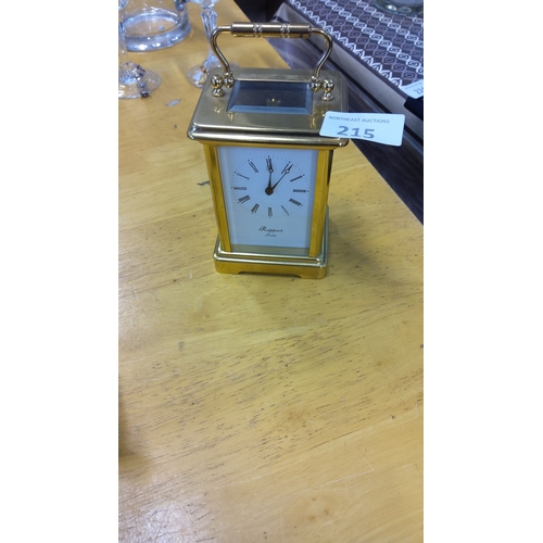 215 - Rapport London brass carriage clock has an elegant design with Roman numerals and glass panels.