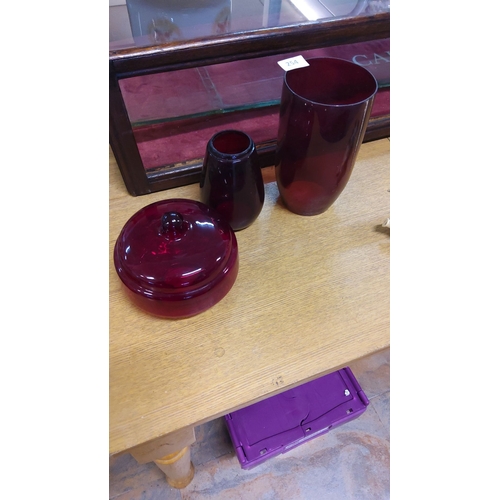 254 - Richly hued ruby glass trio includes cylindrical vase, rounded bowl, and oil lamp base