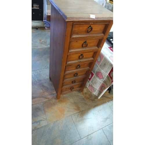 296 - Vintage seven-drawer wooden tallboy, featuring rustic metal ring pulls.