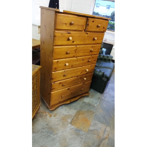 303 - Pine tall chest of drawers, from the late 20th century, features eight spacious drawers and a natura... 