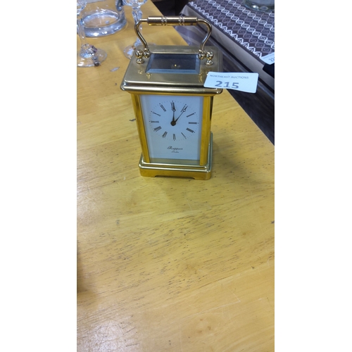 215 - Rapport London brass carriage clock has an elegant design with Roman numerals and glass panels.