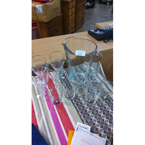 220 - Glassware set includes a large pitcher, ship-motif tumblers, and wine glasses.