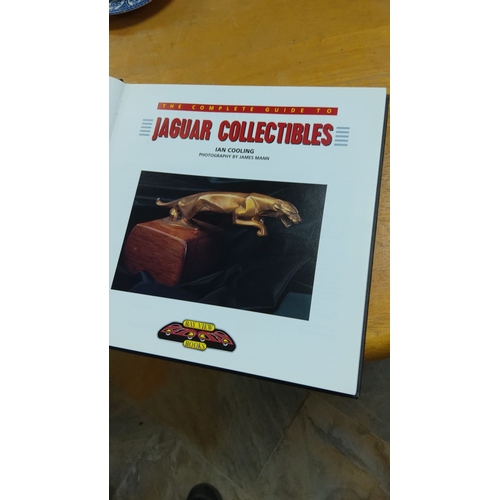 294 - A comprehensive book showcasing Jaguar memorabilia.