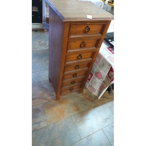 296 - Vintage seven-drawer wooden tallboy, featuring rustic metal ring pulls.