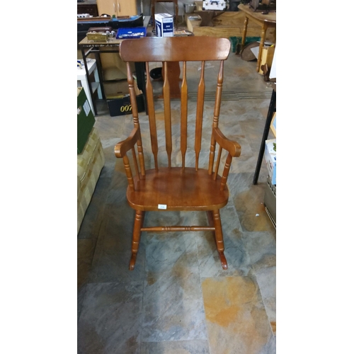 298 - Classic wooden rocking chair, vintage style, features a spindle back and curved arms.