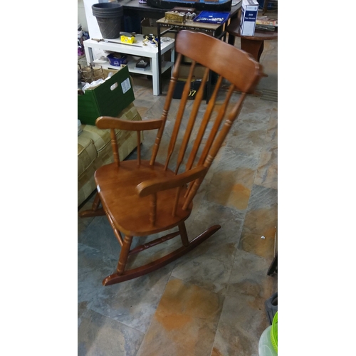 298 - Classic wooden rocking chair, vintage style, features a spindle back and curved arms.