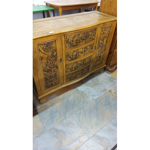 302 - Intricately carved vintage wooden cabinet, featuring scenic relief panels.