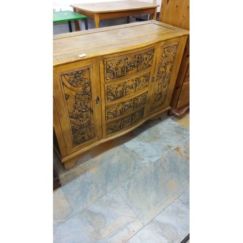 302 - Intricately carved vintage wooden cabinet, featuring scenic relief panels.