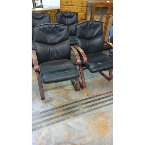 308 - Mid-century modern black leather chairs with curved wooden arms.