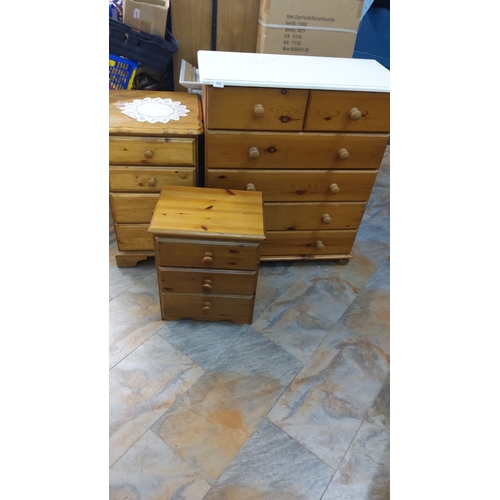 312 - Set of three pine chests of drawers, featuring a natural finish with wooden knobs.