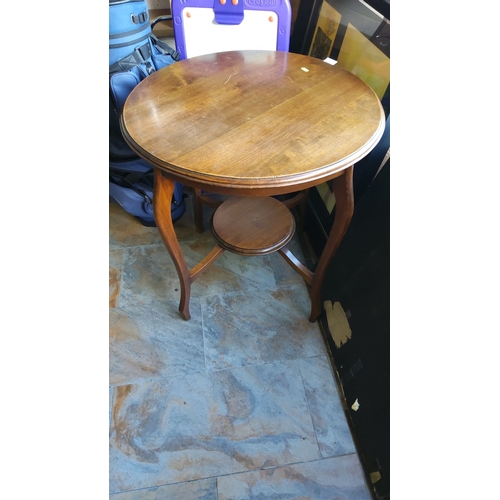 332 - Round wooden window table, featuring elegant cabriole legs and a lower shelf.