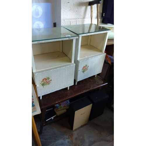 335 - Pair of Mid-Century Modern bedside tables with floral motifs and glass tops, featuring a textured pa... 