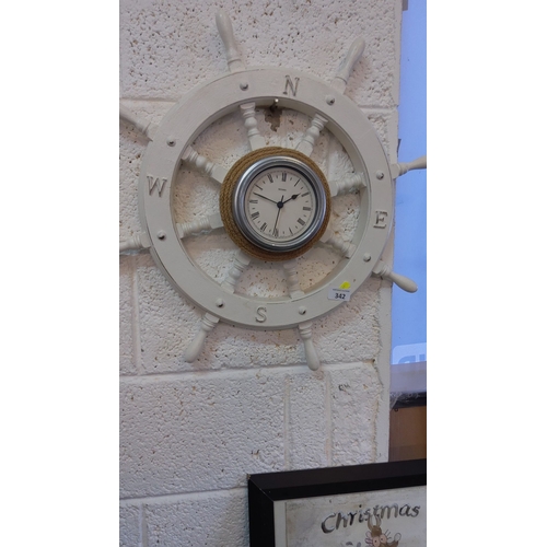 342 - Ship wheel clock with compass directions, nautical design, featuring a central round clock face with... 