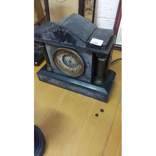 345 - Antique slate mantel clock with Roman numeral dial, featuring classical architectural details.From t... 