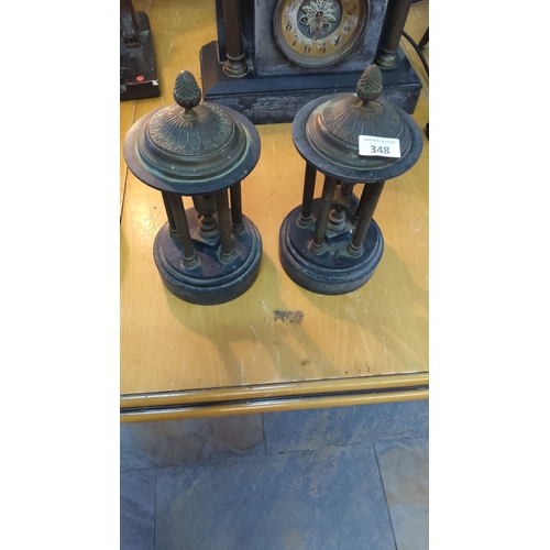 348 - Bronze and slate garnitures, featuring intricate finial designs and classical columns, from the late... 