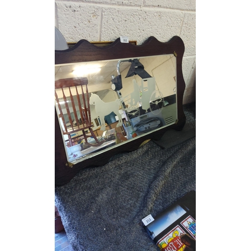 352 - Vintage wall mirror with etched horse and carriage design and a scalloped dark wood frame.