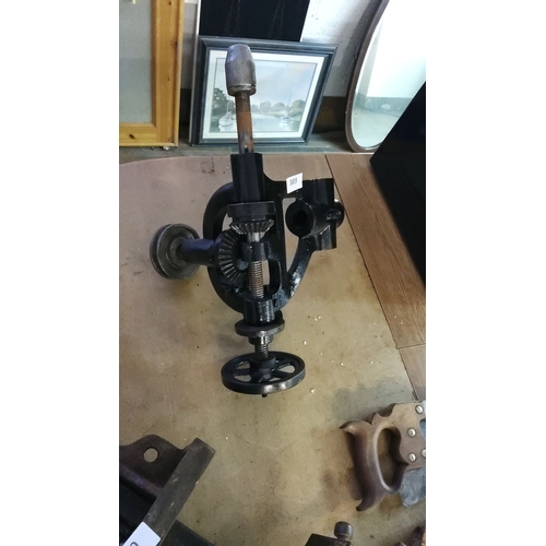 389 - Antique drill stand featuring a metal crank handle and gearing mechanisms, likely used for precise o... 