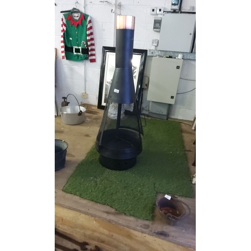 406 - Metal chiminea with mesh design and copper top section. Includes a black metal stand.