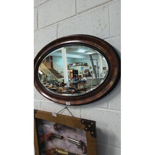 424 - Vintage oval wall mirror with a rich wood veneer frame and original chain