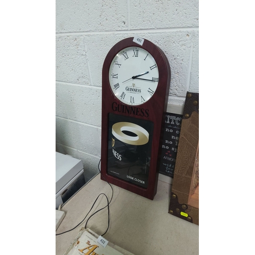 431 - Guinness Wall clock with Roman numerals and promotional design. Classic mahogany finish.(light up)