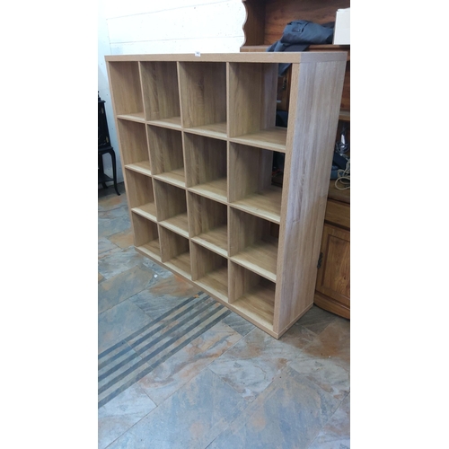 442 - Wooden cube shelving unit with sixteen compartments, made from light oak finish.