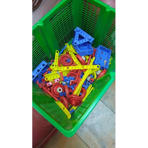 444 - Mixed lot of colorful plastic construction toy pieces in blue, red, and yellow.