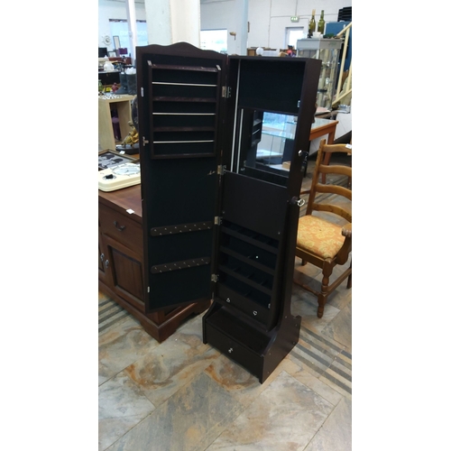 447 - Freestanding black jewelry cabinet with mirror features multiple interior storage compartments and a... 