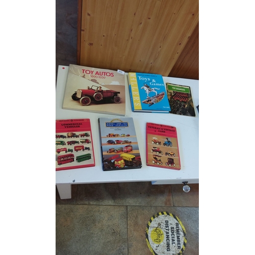 449 - Collection of seven books on toy vehicles and games, including 