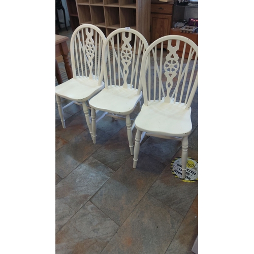 451 - Set of three painted wooden dining chairs with decorative spindle back design.