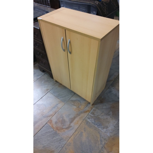 473 - Wooden storage cabinet with two doors, interior shelving, and silver handles.