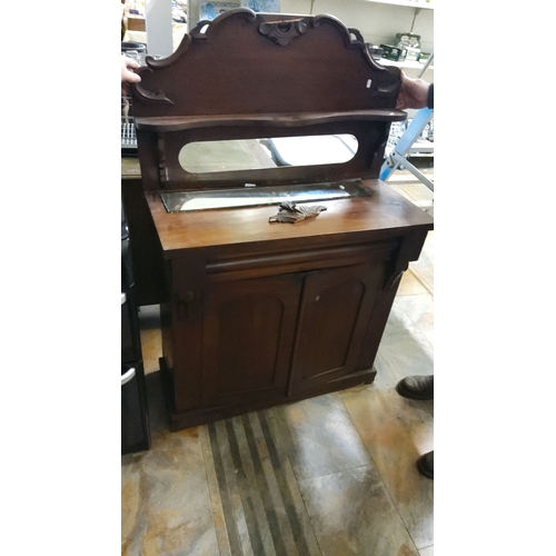 476 - Victorian mahogany washstand with mirrored backsplash and two-door cabinet. Detailed carved accents ... 