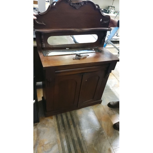 476 - Victorian mahogany washstand with mirrored backsplash and two-door cabinet. Detailed carved accents ... 